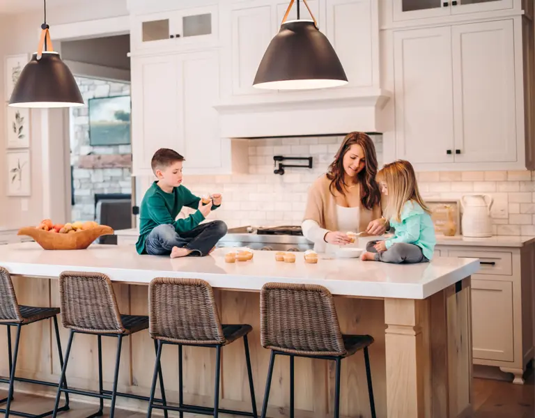 Mother and two children in their kitchen at home.